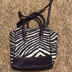 A purple zebra coach purse